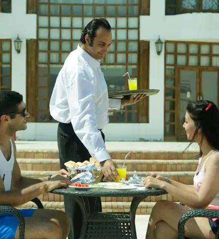 Couple with waiter infront of pool | Miami Beach Egypt